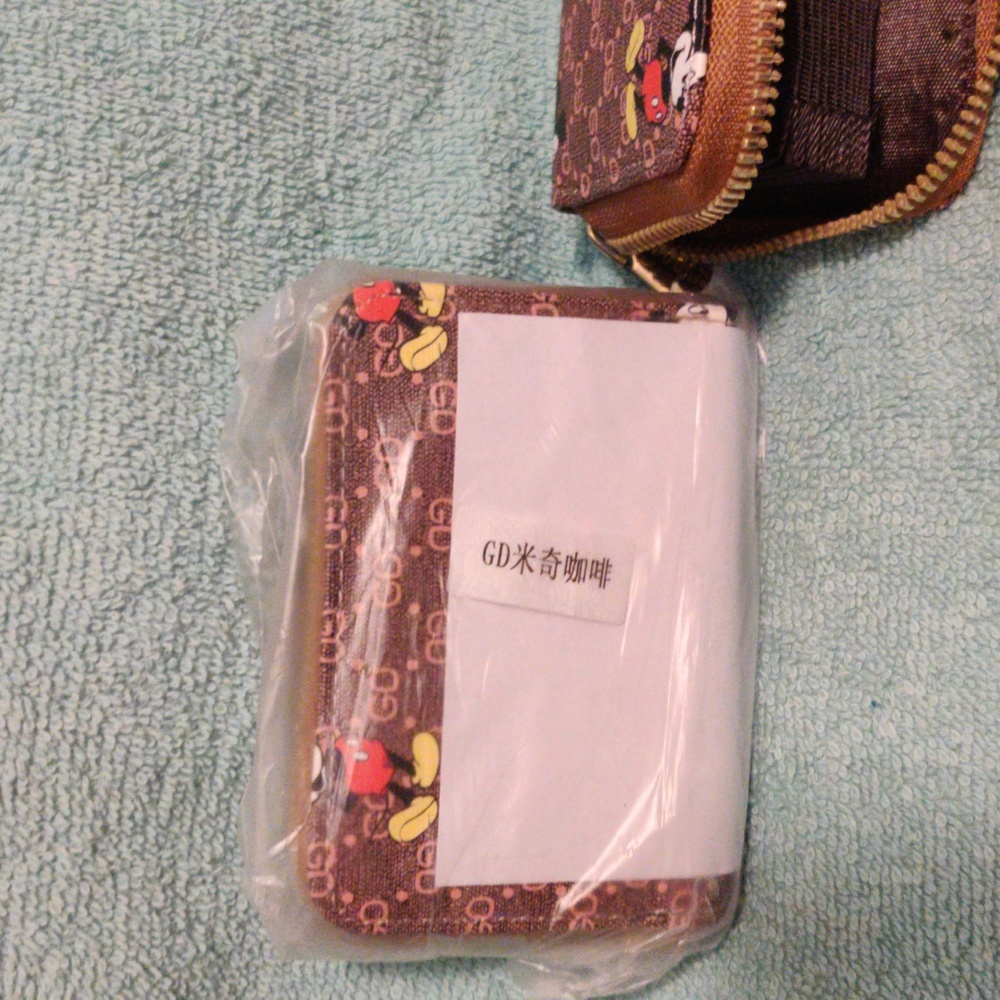 Two brown Mickey Mouse wallets